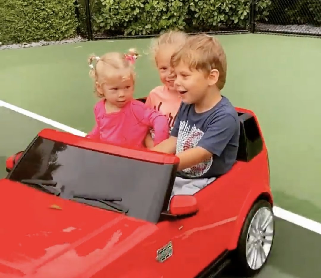 Nicholas, Lucy, and Mary Iglesias riding on a motorized toy car, from a post dated September 19, 2021 | Source: Instagram/annakournikova