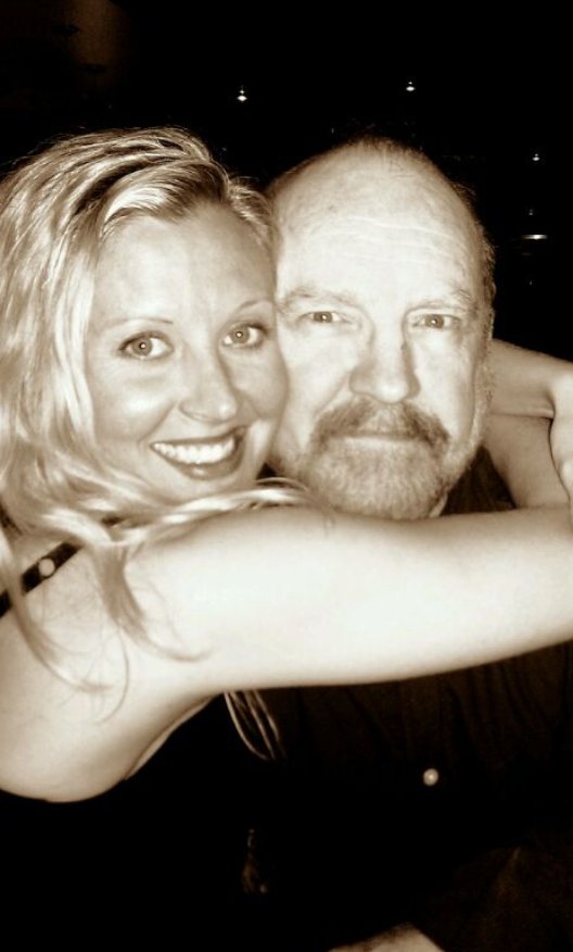 Carrie Anne Fleming embraces Jim Beaver in a close, smiling photo | Source: Facebook/jim.beaver.7731