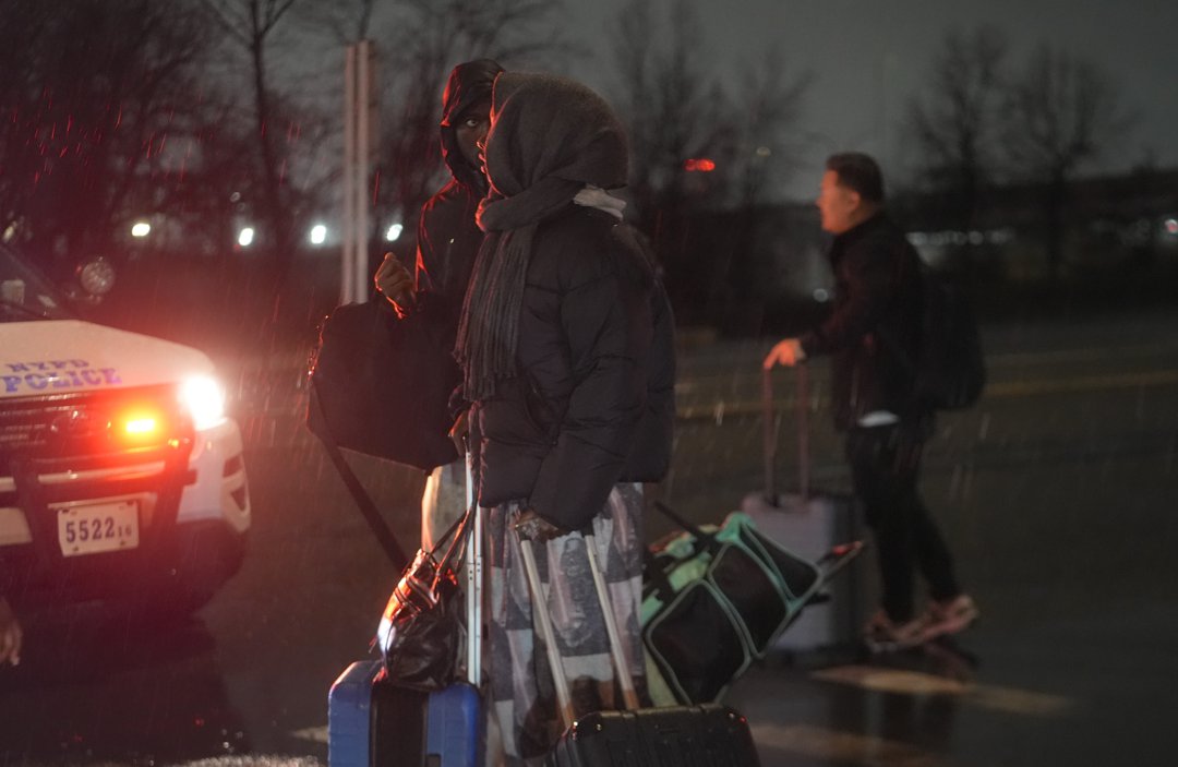 Passengers wait outside Terminal B at LaGuardia Airport following its closure after a deadly runway collision in New York City in March 2026. | Source: Getty Images