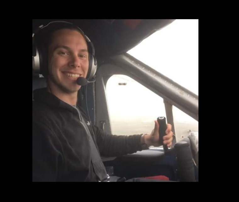 Antoine Forest sits in the cockpit with a headset on, smiling confidently as he grips the controls, capturing a calm, capable presence mid-flight. | Source: Facebook/Antoine Forest