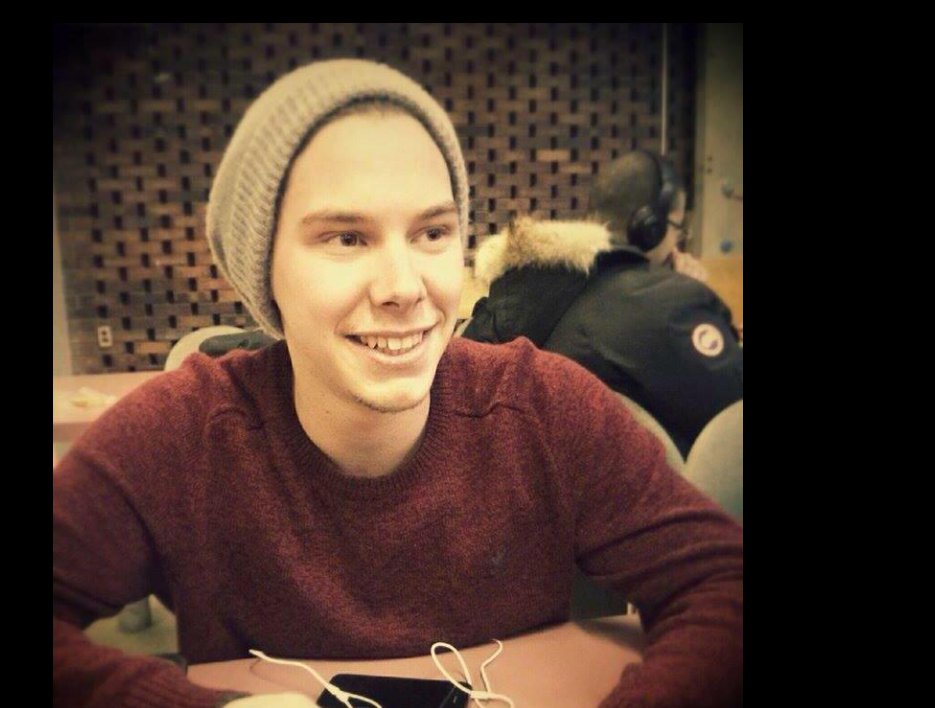 Antoine Forest sits casually in a classroom, smiling mid-conversation, his relaxed posture and beanie giving the moment an easy, everyday warmth. | Source: Facebook/Antoine Forest