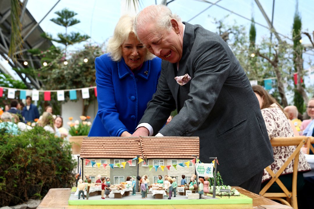 Queen Camilla and King Charles III cut a commemorative cake to mark the 25th anniversary of The Eden Project in Bodelva on 24 March 2026 in Cornwall, England. | Source: Getty Images