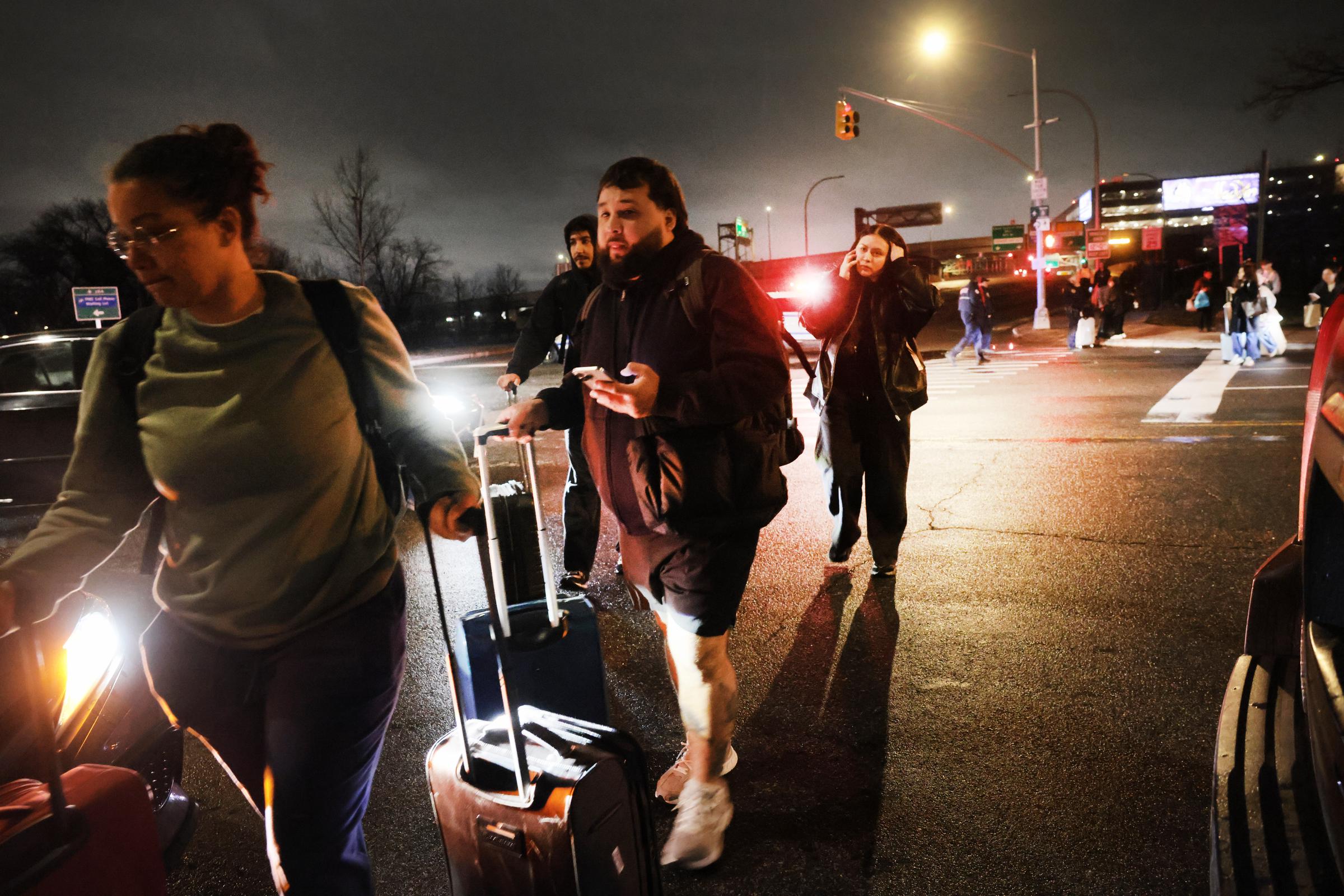 Travelers leave LaGuardia Airport after a collision between an Air Canada Express plane and a fire truck shut down operations in New York City on March 23, 2026 | Source: Getty Images