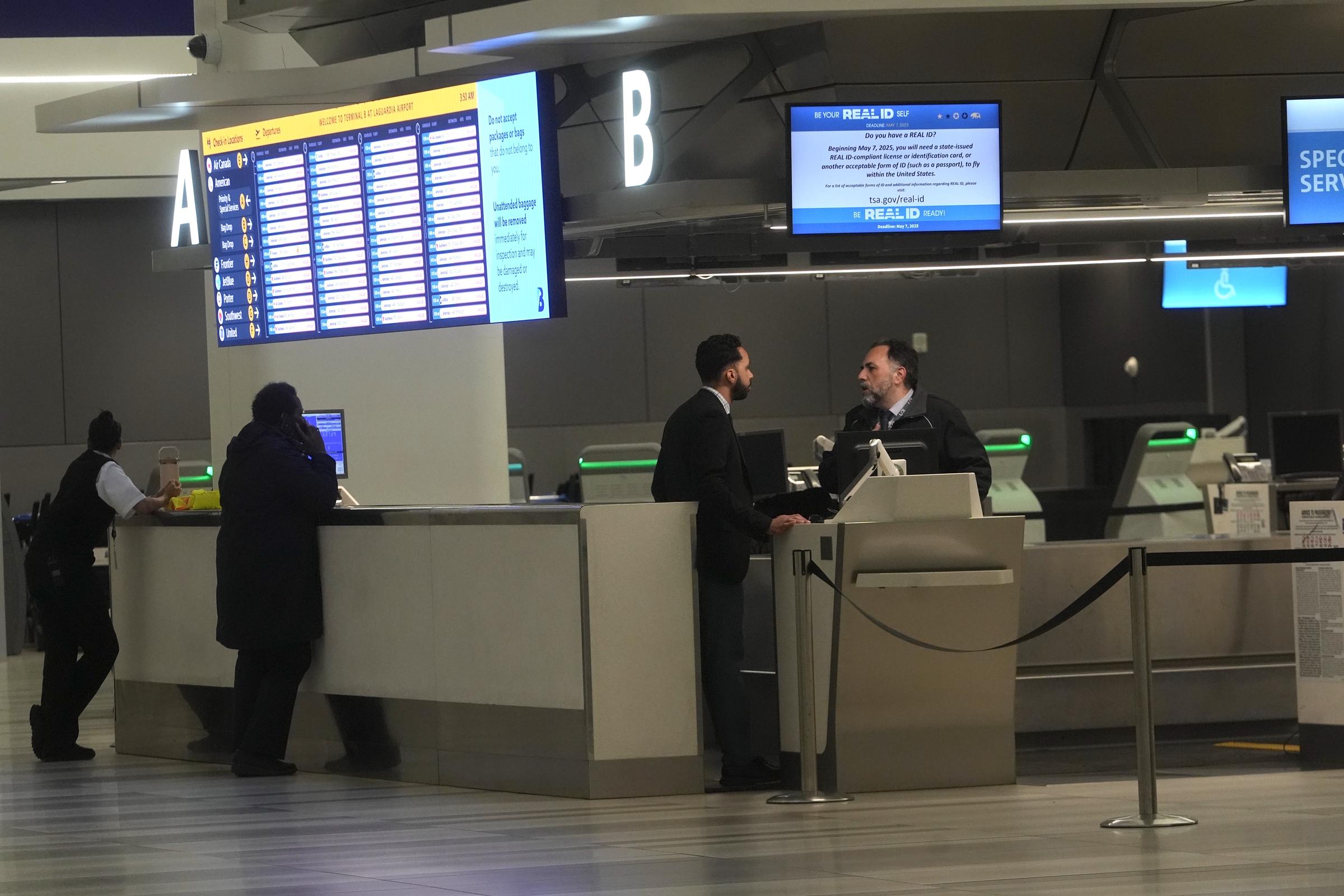 Passengers speak with staff at a service desk at LaGuardia Airport following its closure after a runway collision on March 23, 2026, in New York City | Source: Getty Images