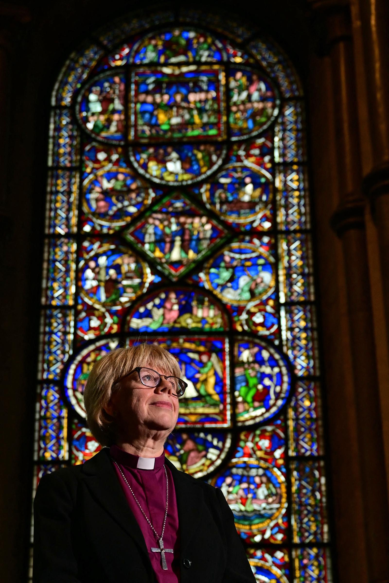 Dame Sarah Mullally photographed in The Corona Chapel at Canterbury Cathedral on 3 October 2025, shortly after the announcement of her appointment as the 106th Archbishop of Canterbury. Behind her, the chapel's ancient stained glass windows have looked down on 105 archbishops before her &mdash; all of them men.