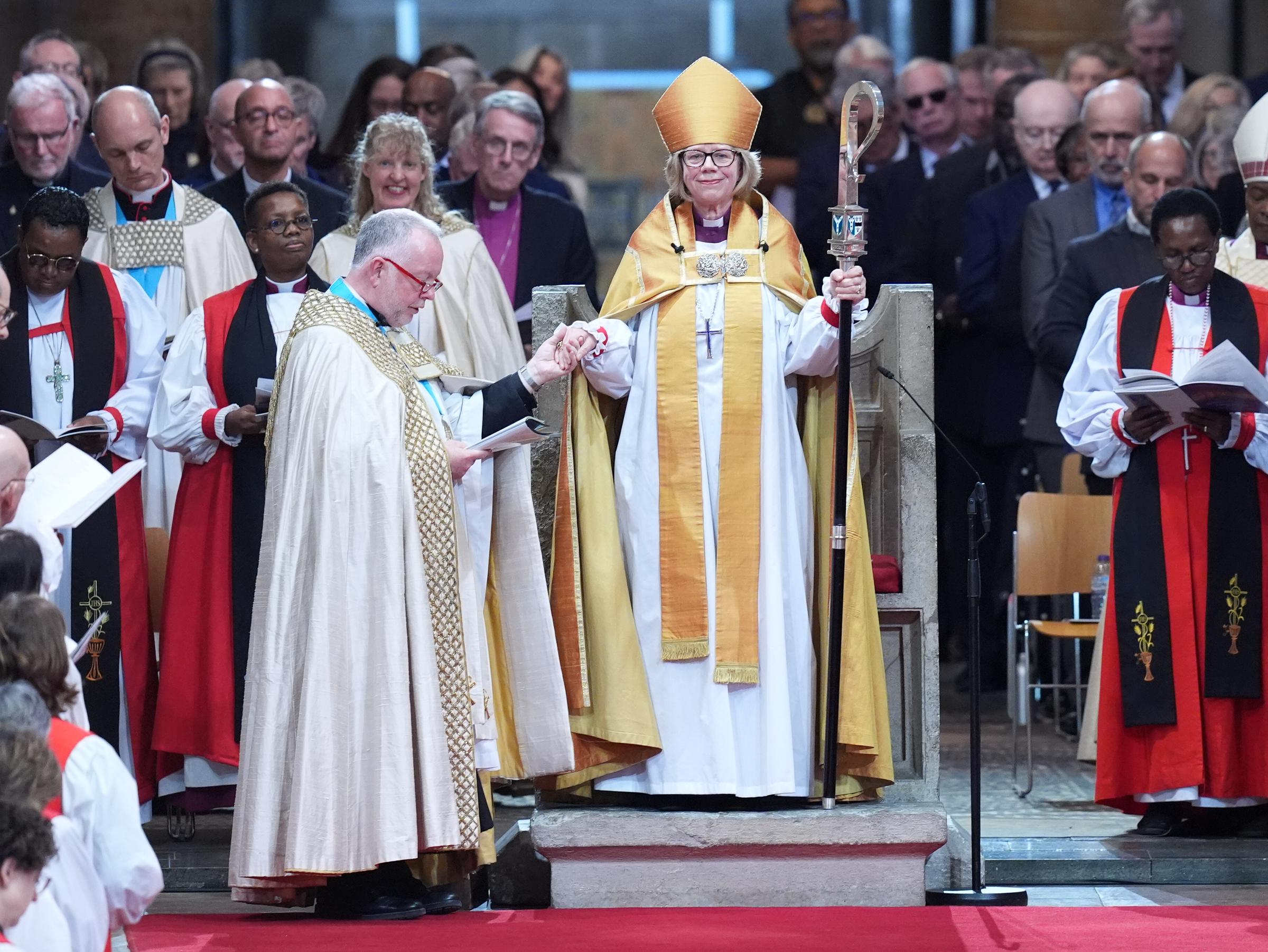 Robed in gold and clutching her pastoral staff, Mullally stood in St Augustine's Chair &mdash; a seat that has held 105 archbishops before her, none of them a woman &mdash; as Dean Monteith took her hand during the enthronement at Canterbury Cathedral on 25 March 2026, the congregation packed in behind her as far as the eye could see.