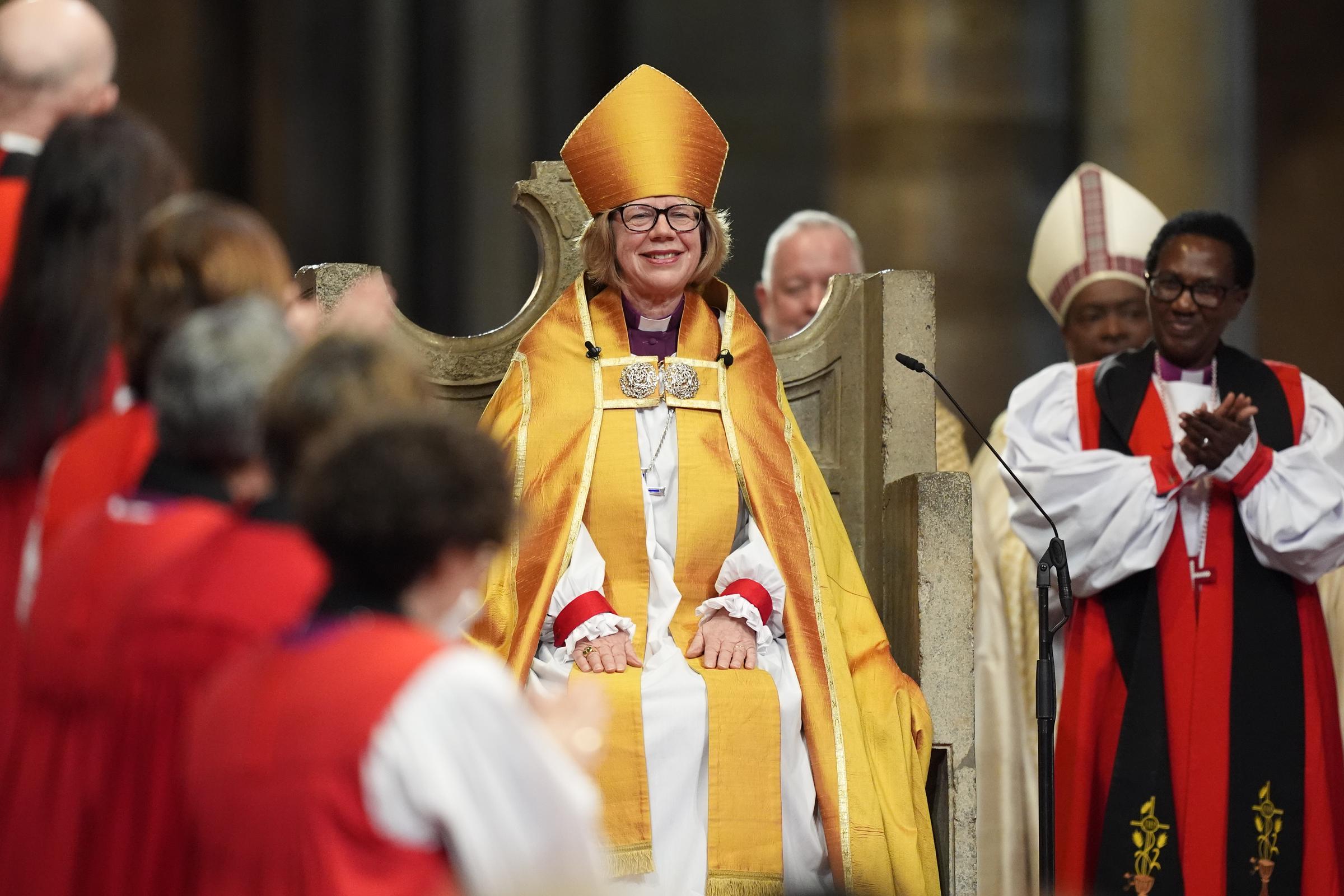 Hands resting calmly in her lap, Mullally sat in the ancient marble seat of St Augustine's Chair on 25 March 2026 &mdash; the first woman in nearly 15 centuries of history to occupy it &mdash; as the clergy gathered around her broke into applause, the sound of it rising through the full length of Canterbury Cathedral.