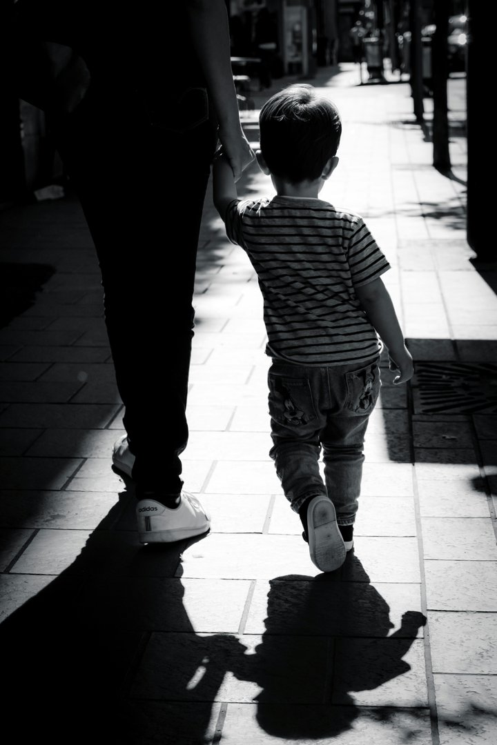 A woman walking with a boy | Source: Unsplash