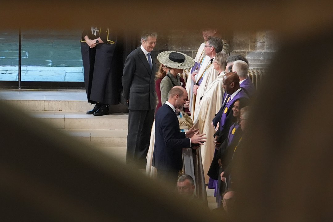 Glimpsed through the crowd, the Princess of Wales's boater hat is still unmistakable, rising above the assembled clergy in their cream and purple robes as Prince William greets one of the officiants. It is a fittingly understated view of a hat that had been anything but understated all day &mdash; now quietly present at the heart of a ceremony that made history.