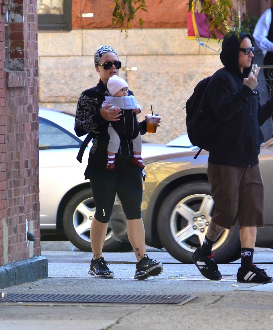 Pink kept things effortlessly low-key as she stepped out in Tribeca, United States, on October 6, 2011, carrying a baby Willow Sage Hart snugly strapped to her chest, while Carey Hart walked alongside them. Dressed in sporty layers and sunglasses, the singer balanced an iced drink in one hand as she navigated the New York pavement.