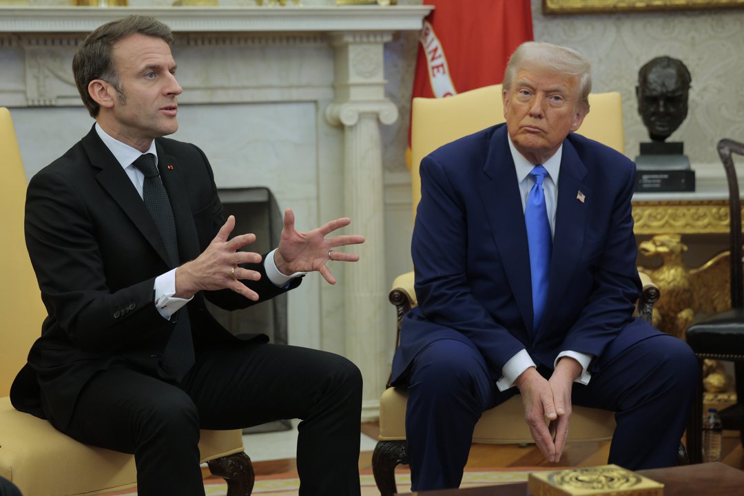 Donald Trump listens as Emmanuel Macron answers a reporter's question in the Oval Office. | Source: Getty Images
