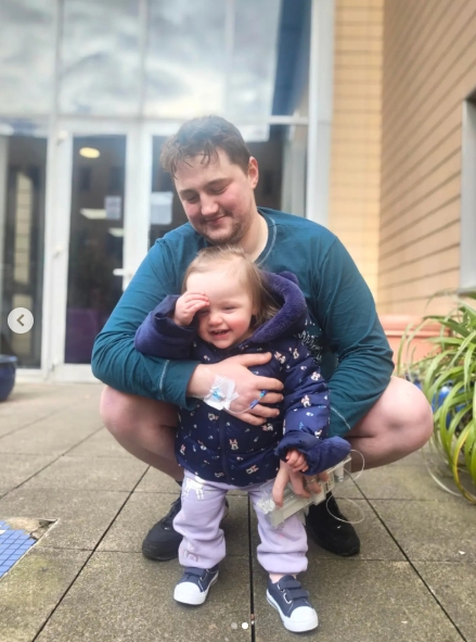 Finnian Garbutt crouched beside his young daughter, Saoirse, smiling as she stood in front of him, in a touching family photo shared in a post dated March 1, 2026. | Source: Instagram/finnstagram20