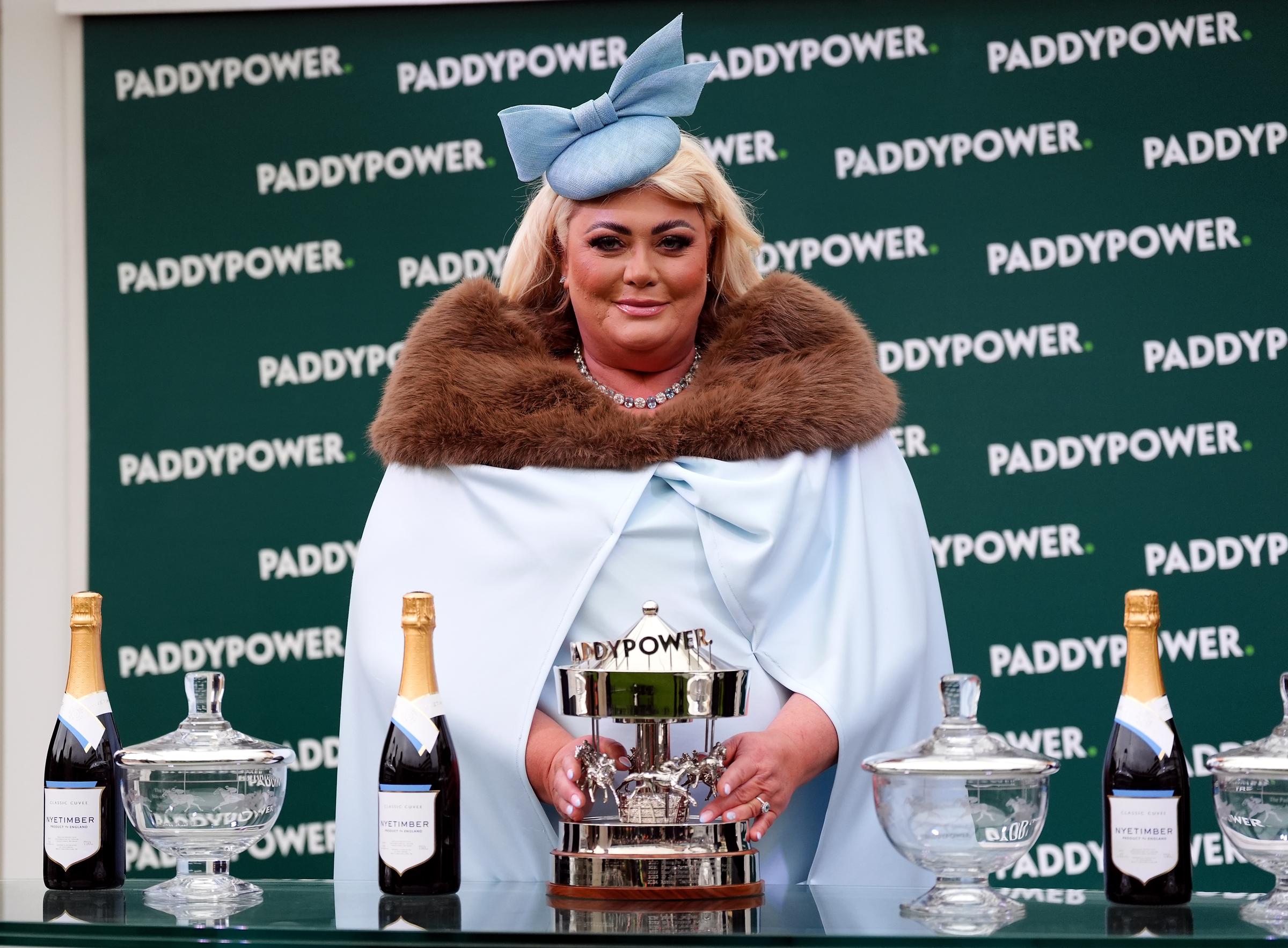 Trophy queen! Collins steals the show at Cheltenham on 13 March 2025, dressed in soft powder blue with a dramatic fascinator, as she proudly poses with the winner's trophy after the Paddy Power Stayers' Hurdle.