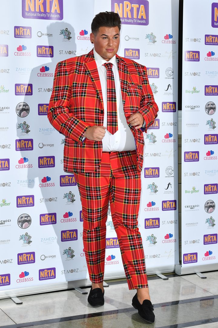 David Potts owns the red carpet at the 2018 National Reality TV Awards, turning heads in a vivid red tartan suit that screams confidence. With a sharp white shirt, matching plaid tie and glossy black loafers, the reality star brings bold flair to Porchester Hall on 25 September.