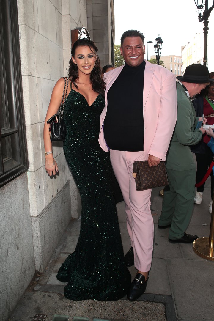Chloe Veitch and Potts bring full glam to the 2023 National Reality TV Awards, arriving arm in arm at Porchester Hall on 31 July. Veitch stuns in a sparkling emerald green gown, while Potts serves pastel perfection in a blush pink tailored suit layered over black &mdash; finishing with polished loafers and a designer clutch.