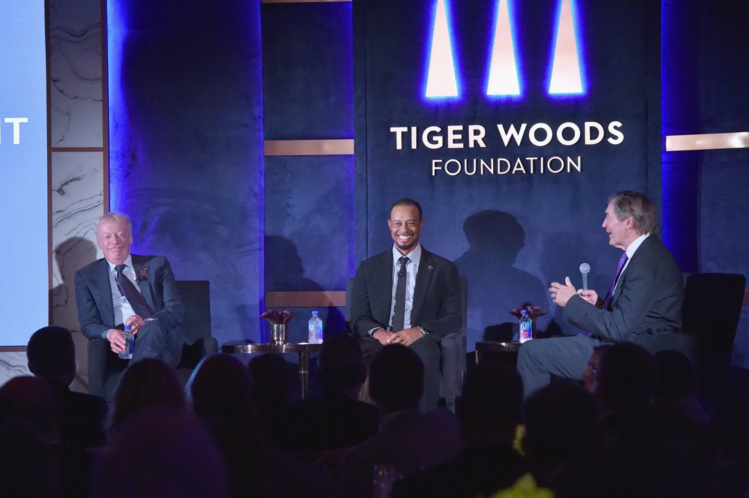 Phil Knight, Tiger Woods, and Charlie Rose speak onstage at the Tiger Woods Foundation’s 20th anniversary celebration in New York City on October 20, 2016. | Source: Getty Images
