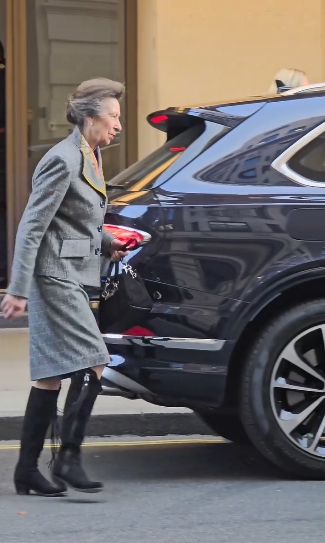 Princess Anne approaches a waiting vehicle outside The Cumberland Hotel in London while dressed in a tailored grey skirt suit trimmed with yellow piping, her sleek black suede riding boots visible as she prepares to enter the car in a clip from a post dated 5 March 2026. | Source: Instagram/kingsguardchannel