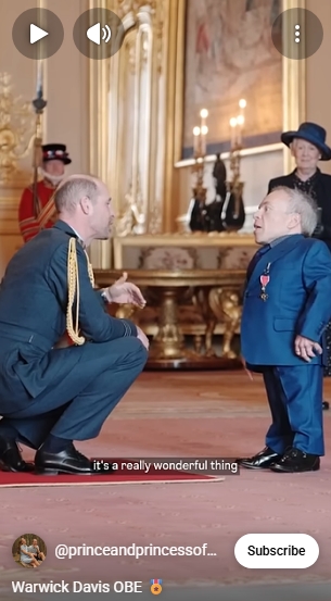 Prince William crouches down to meet Warwick Davis at eye level during the investiture ceremony at Windsor Castle on Wednesday &mdash; the two men engaged in what appears to be a warm conversation. It is a gesture that the actor later described as deeply meaningful, noting how much it meant to him that the Prince of Wales chose to come down to his level rather than look down at him. | Source: YouTube/The Prince and Princess of Wales
