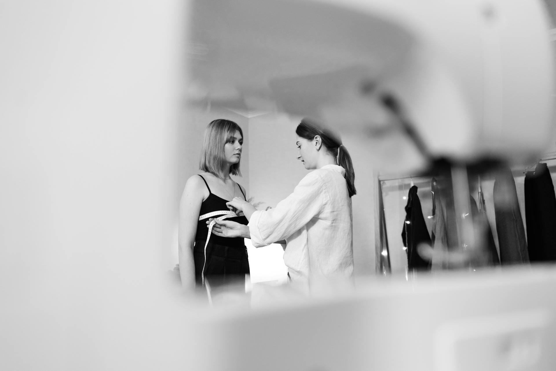 A seamstress measuring her client | Source: Pexels