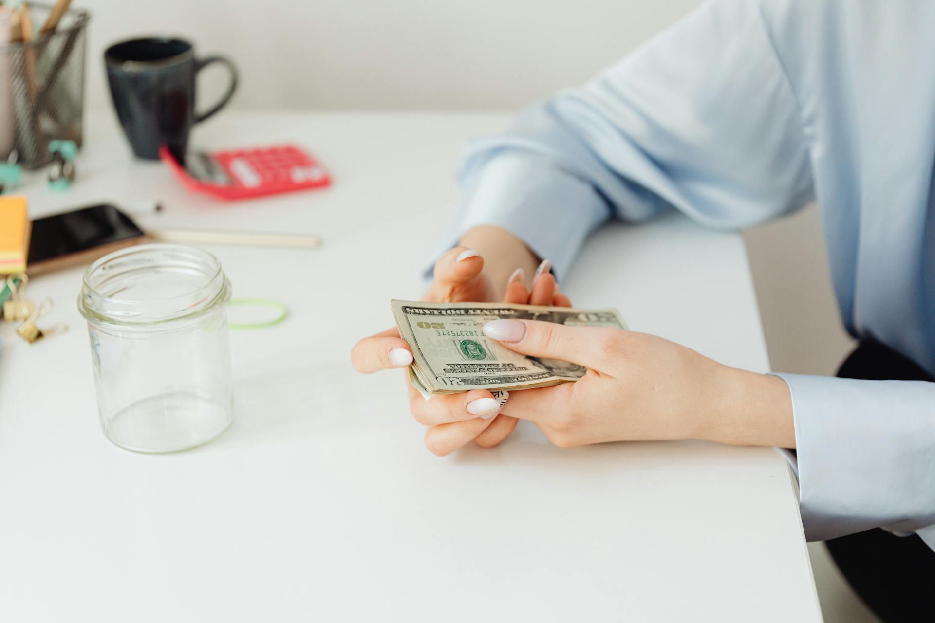 A woman holding money | Source: Pexels