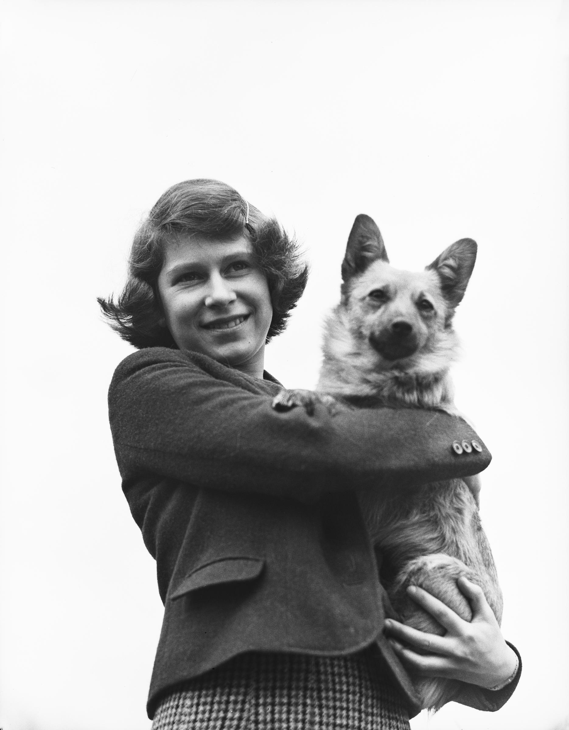 Queen Elizabeth II holding a Pembroke Welsh Corgi dog in April 1940. | Source: Getty Images