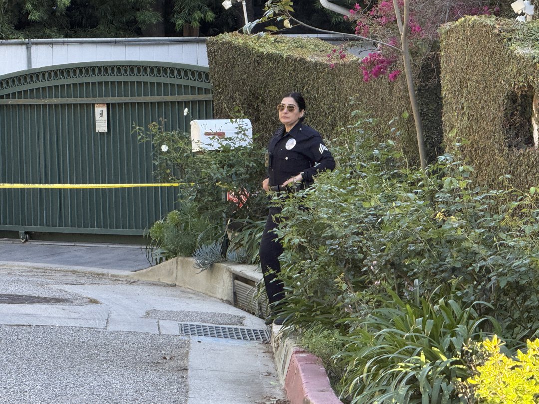 A police officer is seen outside Rihanna's home after a report of gunshots on March 8, 2026 | Source: Getty Images