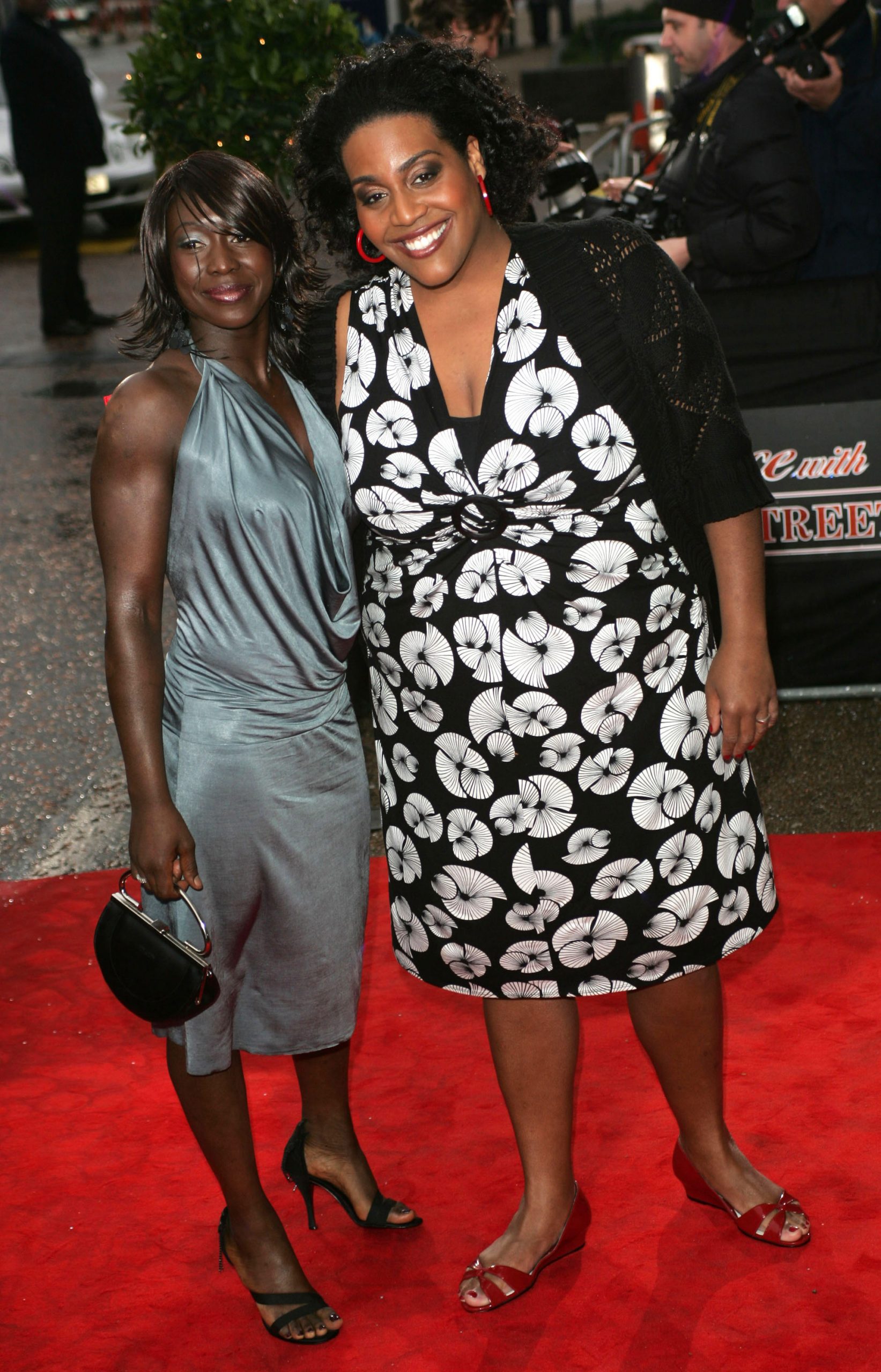 Beaming beside a guest, Hammond arrives arm-in-arm at the red carpet for