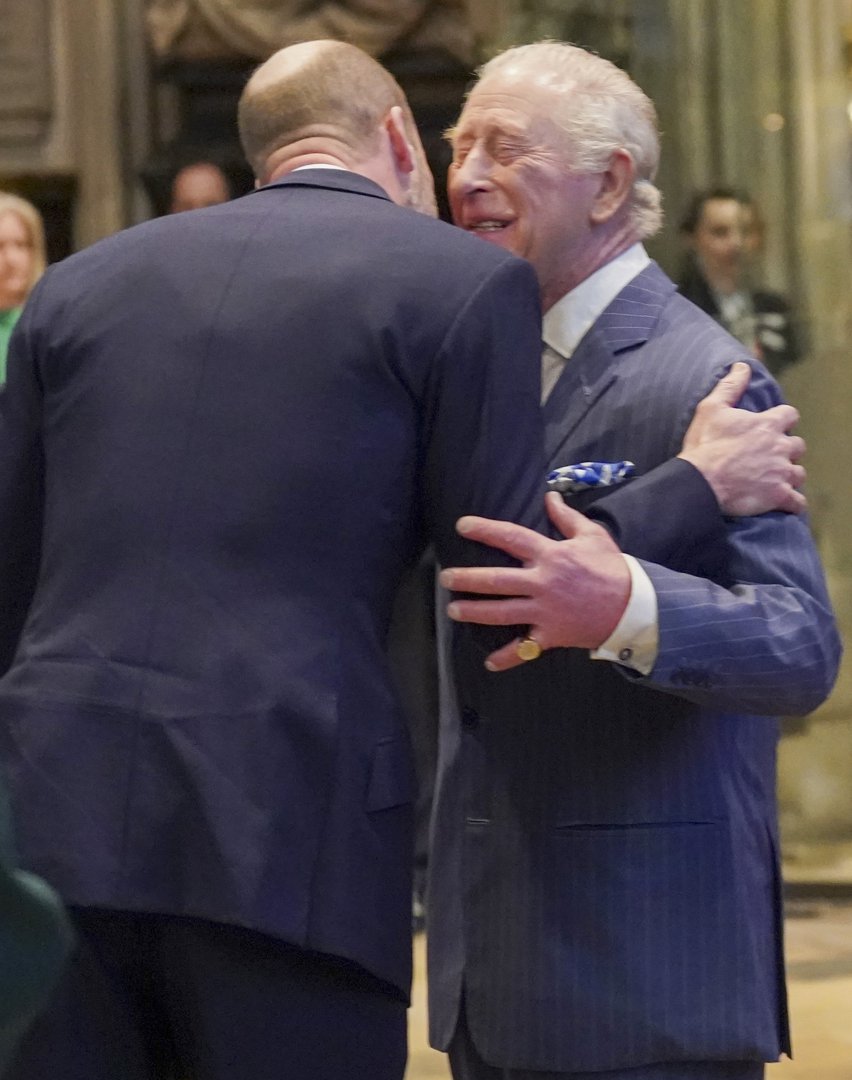 King Charles III smiled as he embraced the Prince of Wales inside Westminster Abbey on 9 March 2026, the King's hands wrapped warmly around his son's back, a blue patterned pocket square peeking from his pinstripe jacket as the family gathered just inside the church ahead of the Commonwealth Day service.