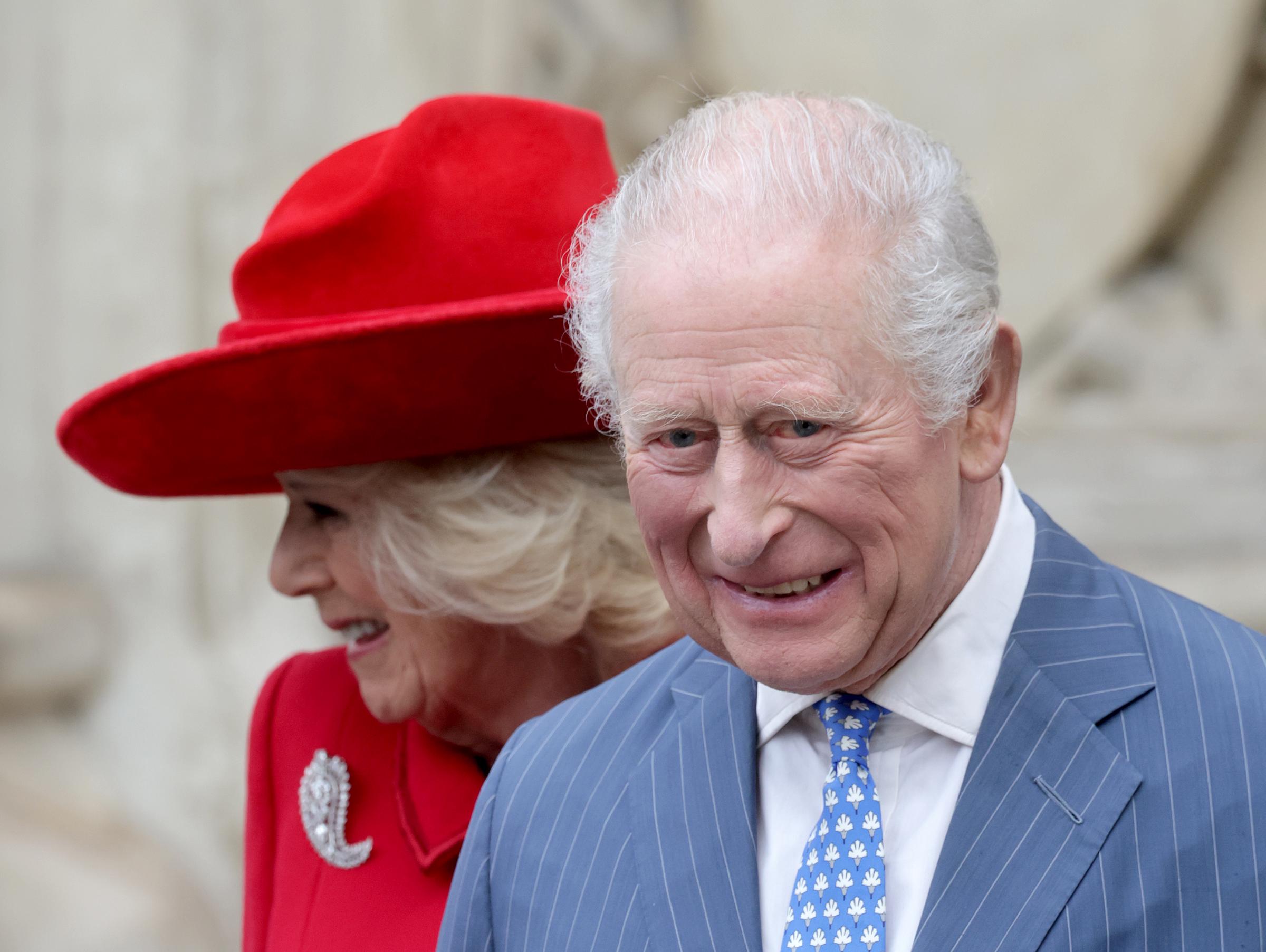 King Charles III, beaming with a broad, warm smile, and Queen Camilla, her sparkling diamond brooch catching the light against her vivid red lapel, were photographed up close as they moved through Westminster Abbey for the Commonwealth Day service on 9 March 2026 in London, presenting a united front on one of the most watched royal occasions of the year.