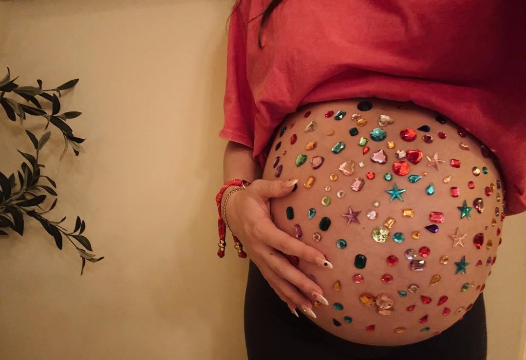 Aree Osbourne poses with her belly adorned with multi-coloured crystals on 28 January 2026. | Source: Instagram/areeosbourne