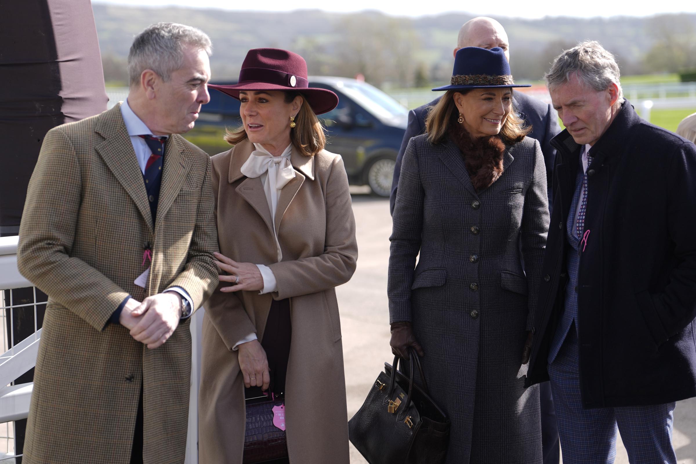 Carole Middleton commands attention in the Princess of Wales's blue Hicks & Brown fedora and a sleek longline grey check coat, her signature dark Herm&egrave;s Birkin bag firmly in hand, as she strolls alongside actor James Nesbitt and broadcaster Natalie Pinkham on Day 2 of the 2026 Cheltenham Festival at Cheltenham Racecourse on Wednesday, 11 March.