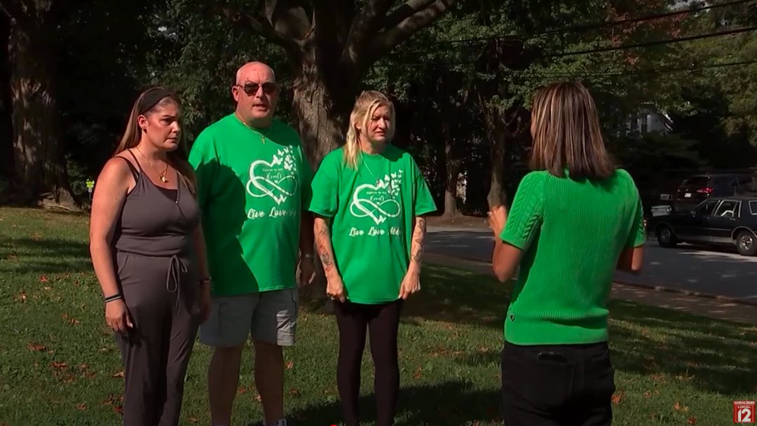 Lori Kralle with loved ones and a reporter. | Source: YouTube/Local 12