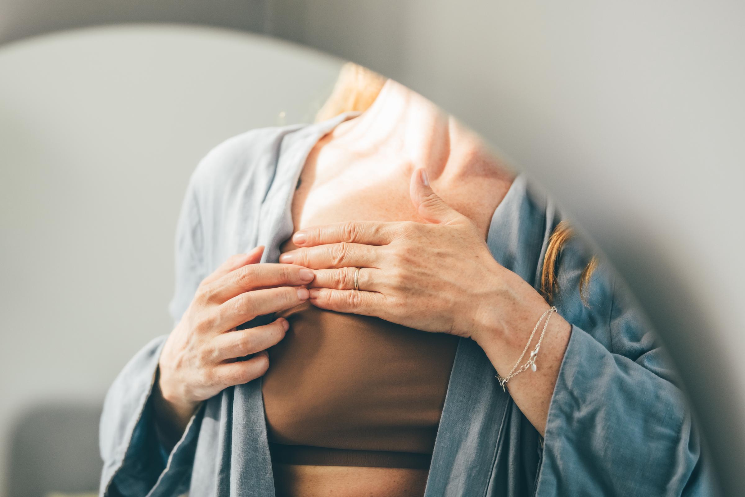 A woman assessing her breast | Source: Getty Images