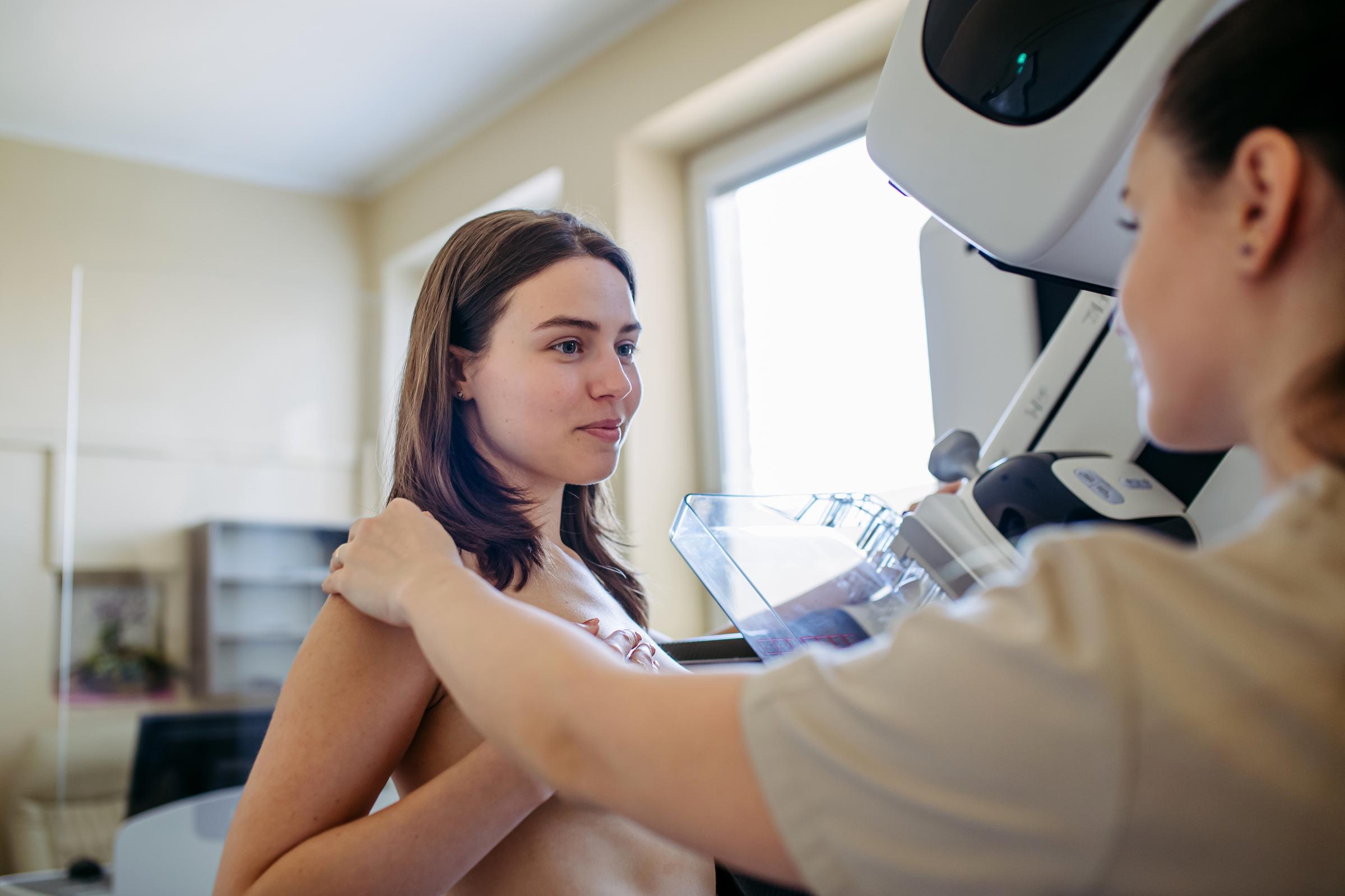 A healthcare worker talking with a female patient during a mammogram screening | Source: Getty Images