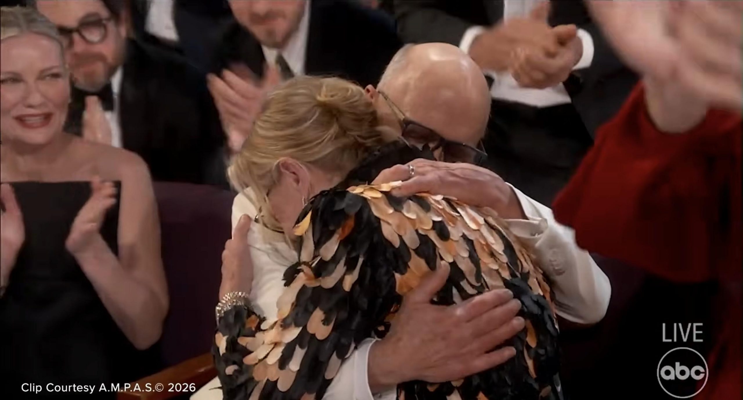 Amy Madigan shares an emotional embrace after hearing her name called | Source: YouTube/ABCNews
