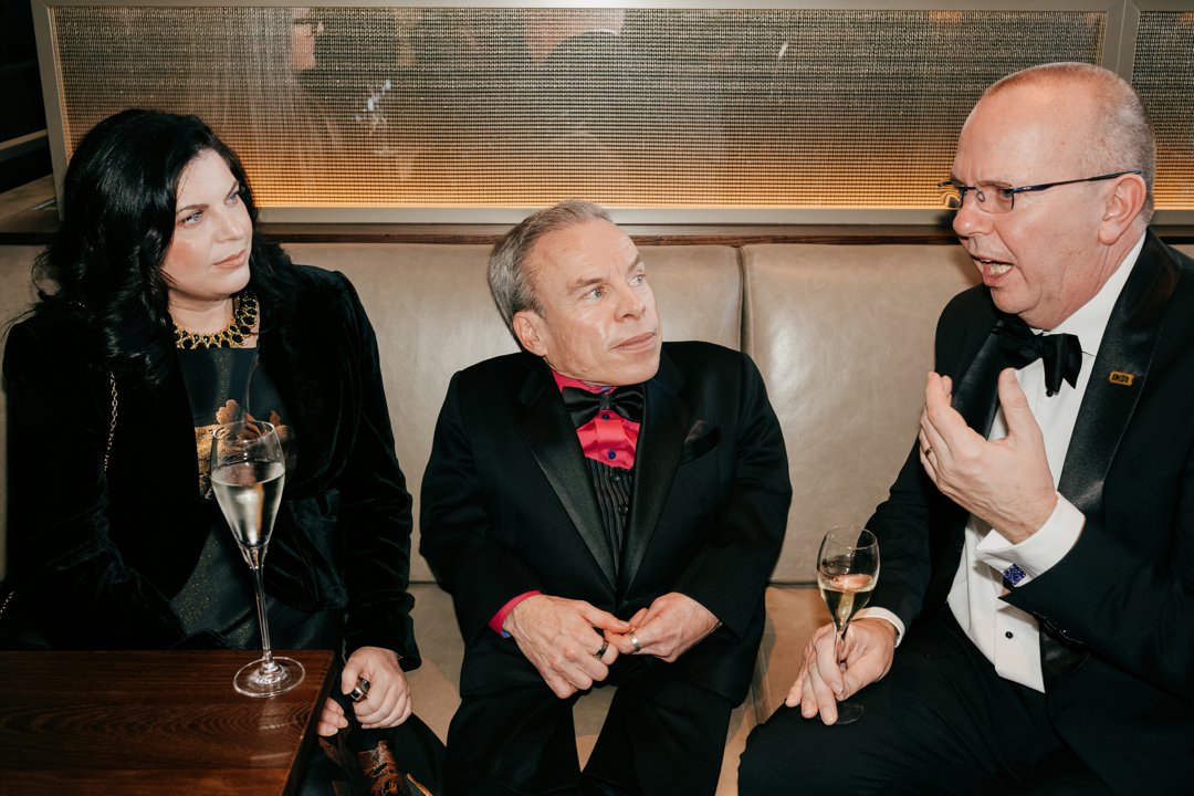 Guest (L), Warwick Davis (C) and Col Needham (R) attend the EE BAFTA Film Awards 2026 Champagne Reception at The Royal Festival Hall on 22 February 2026 in London, England. | Source: Getty Images