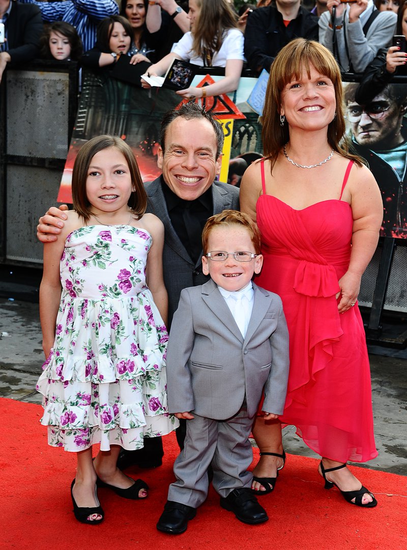 A younger Warwick Davis beams on the red carpet at the world premiere of