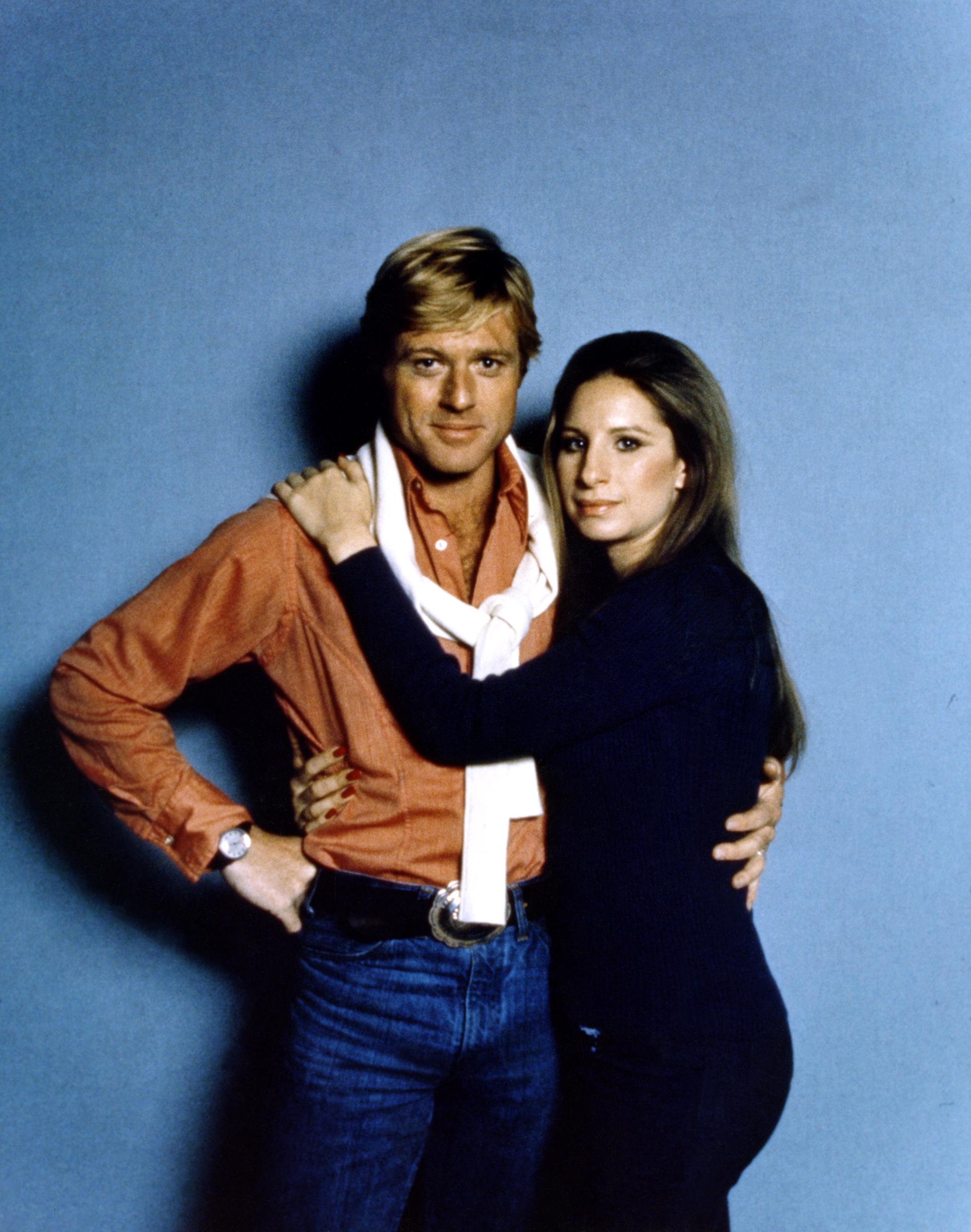 Robert Redford and Barbra Streisand posing on the set of 