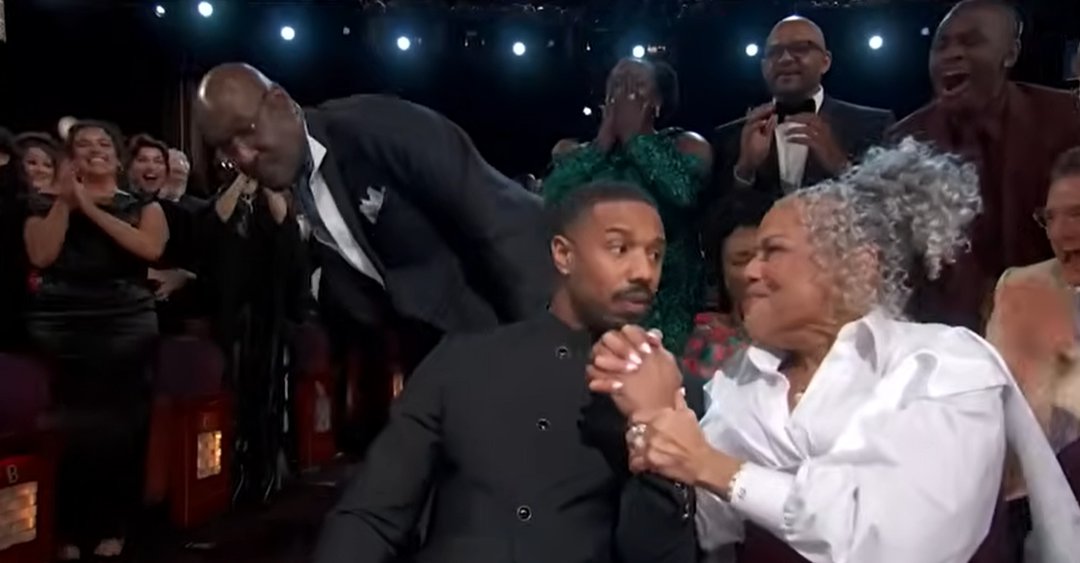Donna Jordan reaches for her son&rsquo;s hand and squeezes it tightly, her face glowing with emotion as Michael B. Jordan looks momentarily stunned beside her. | Source: YouTube/ABCNews